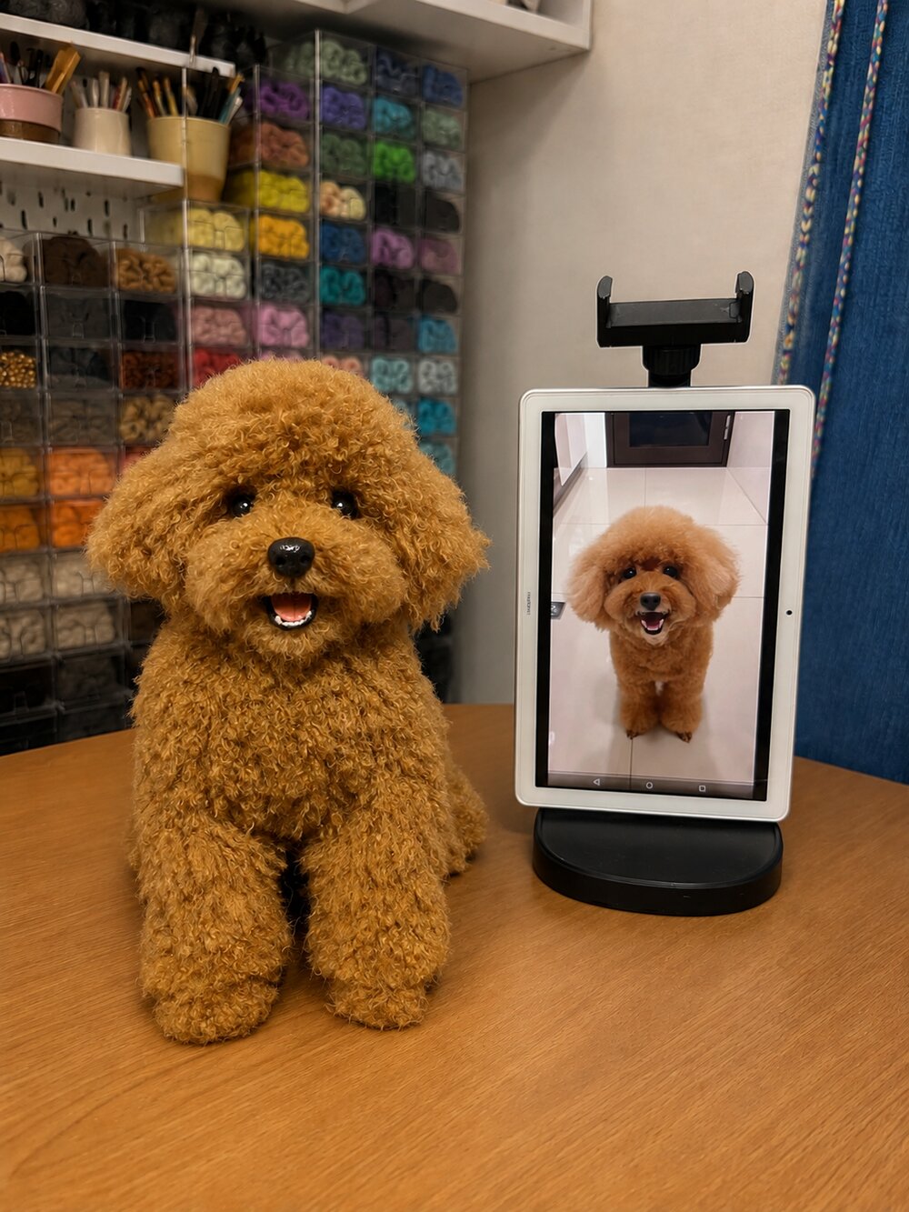 Handmade brown poodle pet replica displayed beside the customer's reference photo on a tablet.