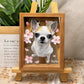 Custom glass pet portrait of a white and tan Chihuahua named NiuNiu with pink floral details, displayed in a wooden frame on an easel.