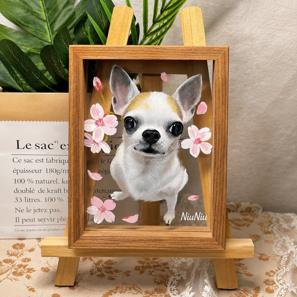 Custom glass pet portrait of a white and tan Chihuahua named NiuNiu with pink floral details, displayed in a wooden frame on an easel.