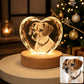 Personalized dog photo engraved inside a heart-shaped crystal night light with a warm wooden LED base, shown beside the original pet photo.