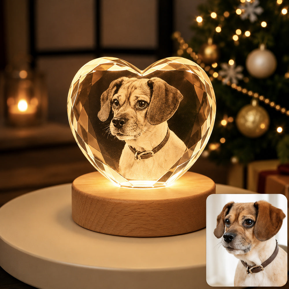 Personalized dog photo engraved inside a heart-shaped crystal night light with a warm wooden LED base, shown beside the original pet photo.