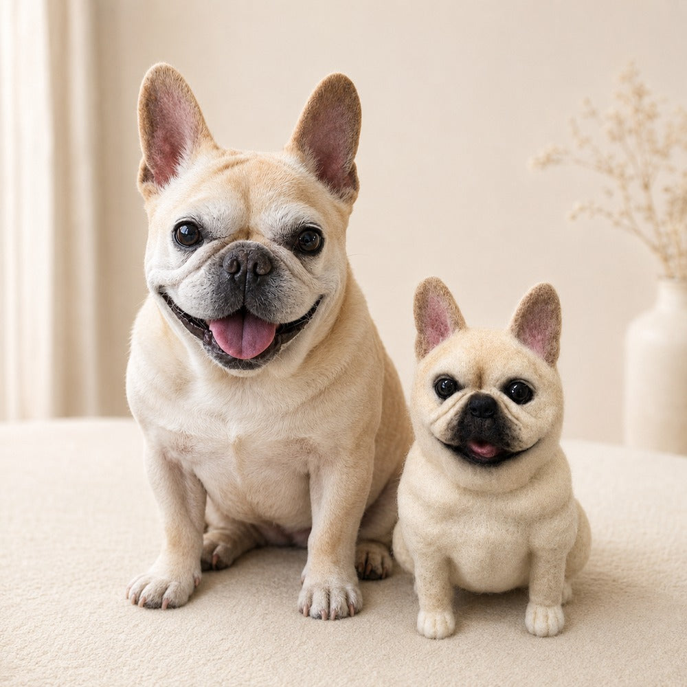 Real cream French Bulldog sitting beside a custom handmade wool-felt pet replica created to match its appearance.