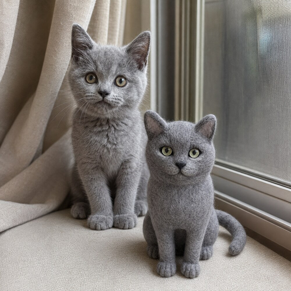Real gray kitten sitting beside a custom handmade wool-felt cat replica with matching coat color, eyes and facial features.