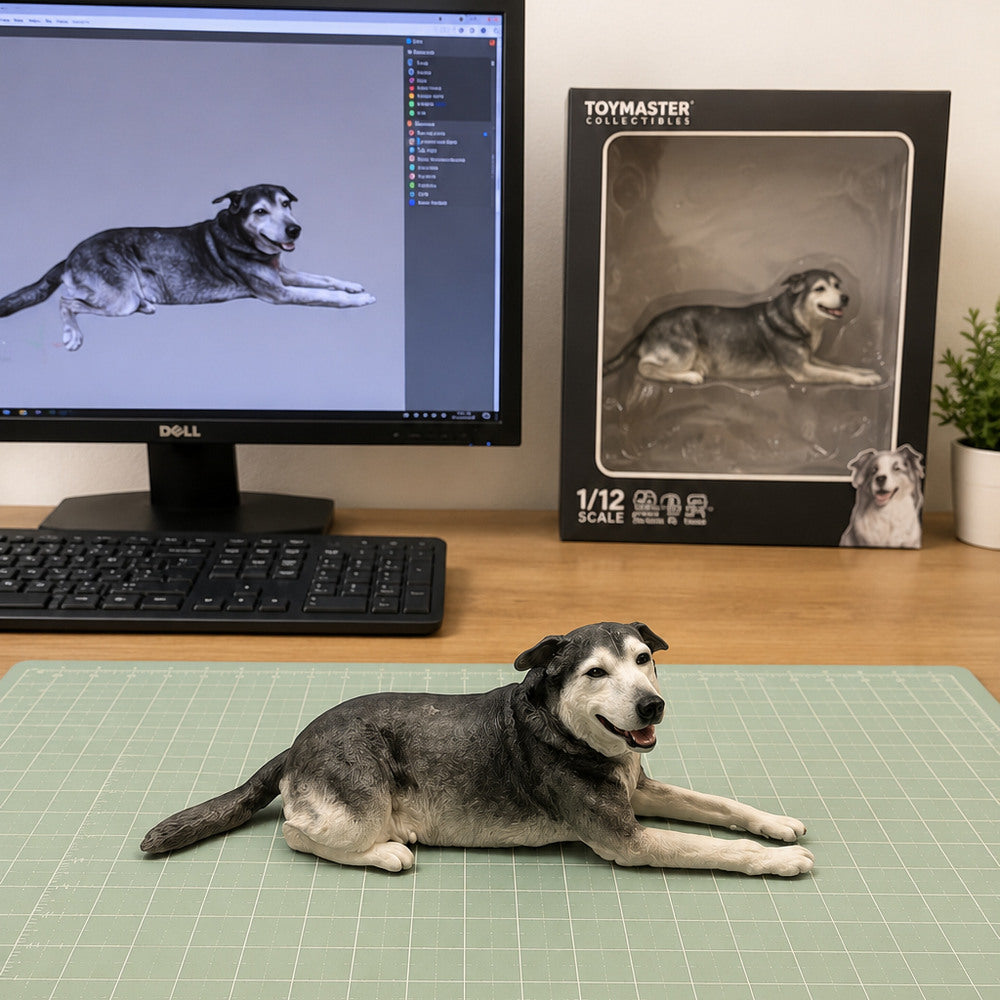 Custom black and gray senior dog figurine in a relaxed lying pose, displayed beside its digital 3D design and collectible packaging.