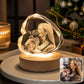 Personalized photo of a woman kissing her French Bulldog engraved inside a faceted heart-shaped crystal night light with a warm wooden LED base.
