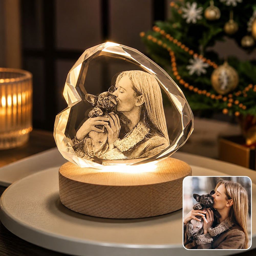 Personalized photo of a woman kissing her French Bulldog engraved inside a faceted heart-shaped crystal night light with a warm wooden LED base.