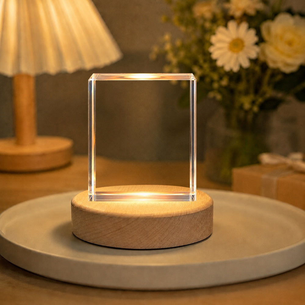 Clear rectangular crystal pet portrait night light glowing on a wooden LED base in a warm home setting.