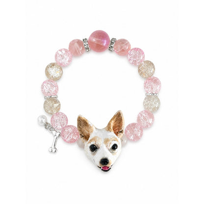 Handmade white-and-tan small dog portrait bracelet with pink and gray crystal beads on white.