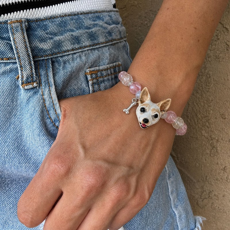 Personalized white-and-tan small dog portrait bracelet worn with pink and gray crystal beads.