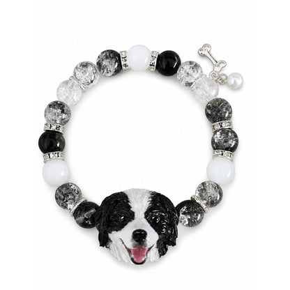 Custom black-and-white dog portrait bracelet with black, gray and clear crystal beads on white.