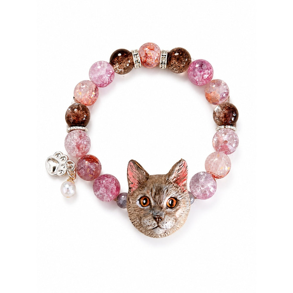 Handmade gray-brown cat portrait bracelet with orange eyes and pink crystal beads on white.