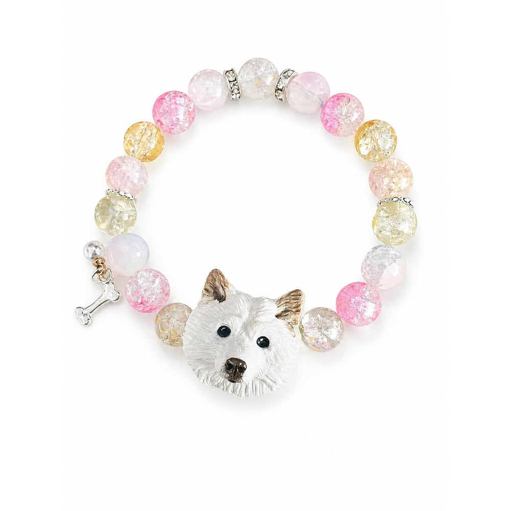 Handmade white upright-ear fluffy dog portrait bracelet with pink, yellow and clear beads on white.