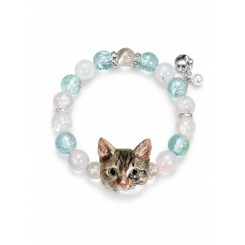 Custom tabby cat portrait beaded bracelet with aqua and clear crystal beads on white.