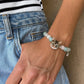 Personalized tabby cat portrait bracelet worn on the wrist with aqua and clear crystal beads.