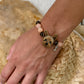 Personalized Yorkshire terrier portrait bracelet worn on the wrist with peach and brown crystal beads.