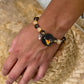 Personalized pet bird portrait bracelet worn on the wrist with black and amber crystal beads.