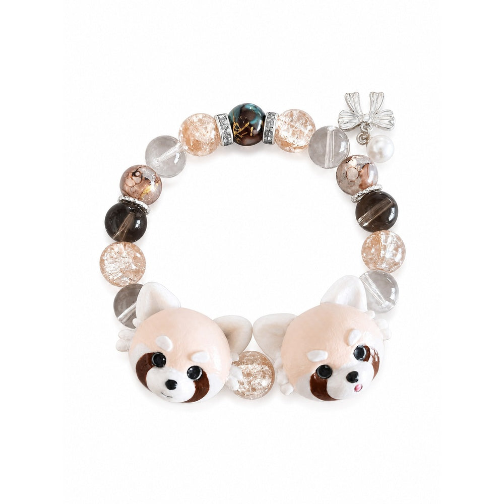 Handmade two-red-panda portrait beaded bracelet with peach, brown and clear beads on white.