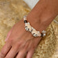 Personalized two-red-panda portrait bracelet worn on the wrist with peach and neutral crystal beads.
