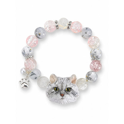Custom gray long-haired cat portrait beaded bracelet with gray, pink and clear beads on white.