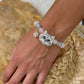 Personalized gray long-haired cat portrait bracelet worn with gray, pink and clear crystal beads.