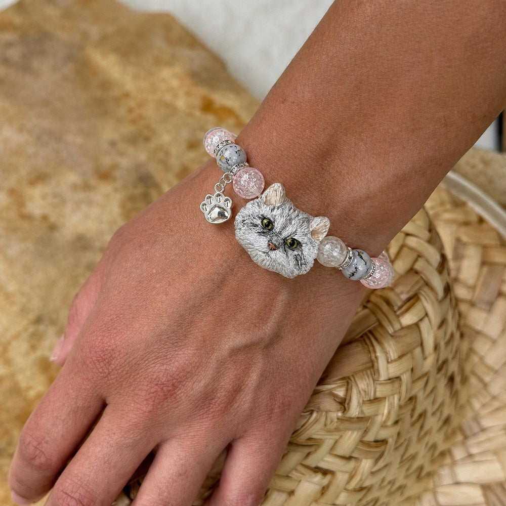 Personalized gray long-haired cat portrait bracelet worn with gray, pink and clear crystal beads.