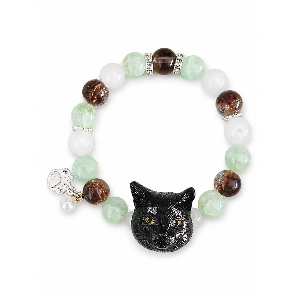 Handmade black cat portrait beaded bracelet with green, brown and white crystal beads on a white background.