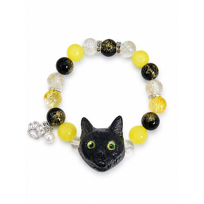 Custom black cat portrait beaded bracelet with bright yellow and black crystal beads on white.