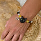 Personalized black cat portrait bracelet worn on the wrist with yellow and black crystal beads.