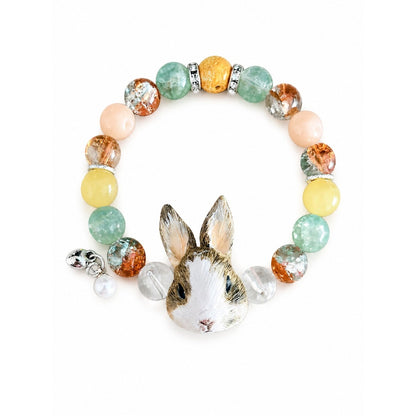 Handmade custom two-rabbit portrait beaded bracelet with multicolor crystal beads on a white background.