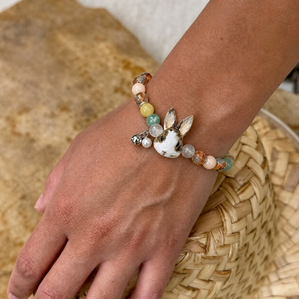 Personalized two-rabbit portrait beaded bracelet worn on the wrist with multicolor crystal beads.