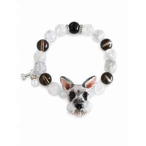 Handmade Schnauzer portrait beaded bracelet with black, brown and clear crystal beads on white.
