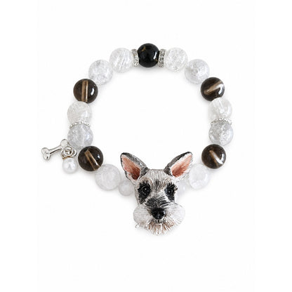 Handmade Schnauzer portrait beaded bracelet with black, brown and clear crystal beads on white.