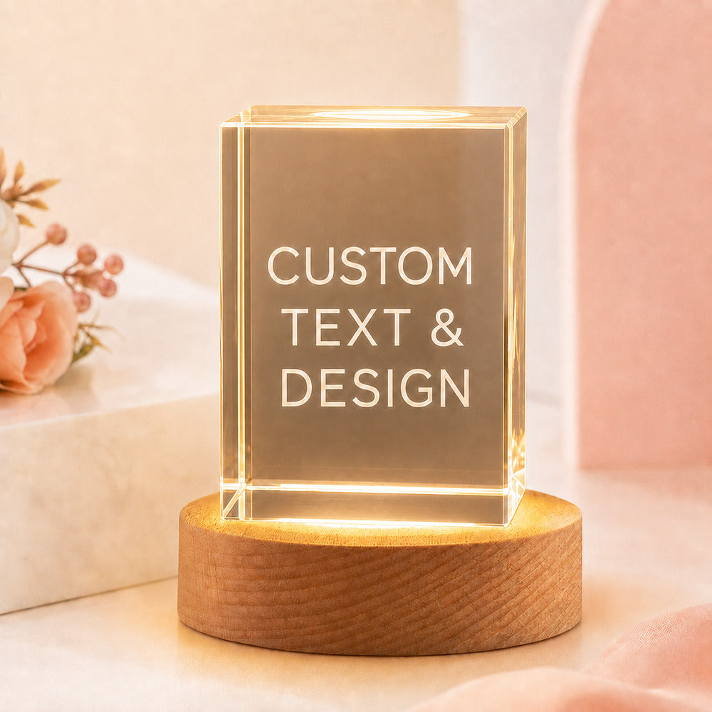 Personalized square crystal night light with custom text and design displayed on a warm wooden LED base.