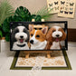 Custom glass pet portrait of three dogs named Hope, Alfie and Nova, displayed in a black frame on a wooden easel.