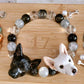 Custom two-dog portrait crystal bracelet with black, clear and silver beads and two hand-sculpted dog face charms.