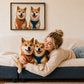 Woman hugging two Shiba Inu dogs beneath their custom glass pet portrait in a cozy living room.