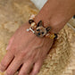 Custom Yorkshire Terrier portrait bracelet worn on the wrist with a hand-sculpted dog face charm and warm crystal beads.
