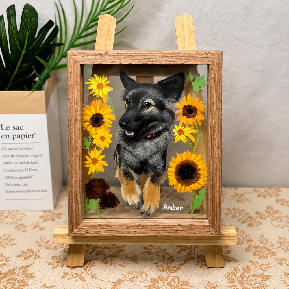 Custom floral pet portrait of a black and tan dog named Amber, framed with bright sunflower details and displayed on a wooden easel.