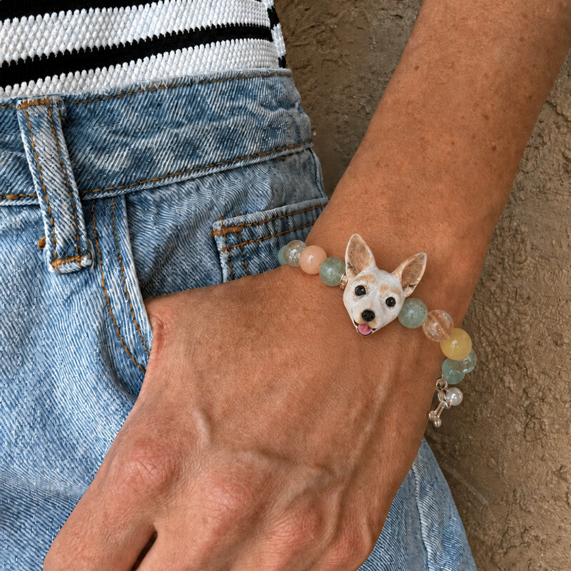 Personalized Chihuahua portrait crystal bracelet worn on the wrist with a custom dog face charm and pastel beads.