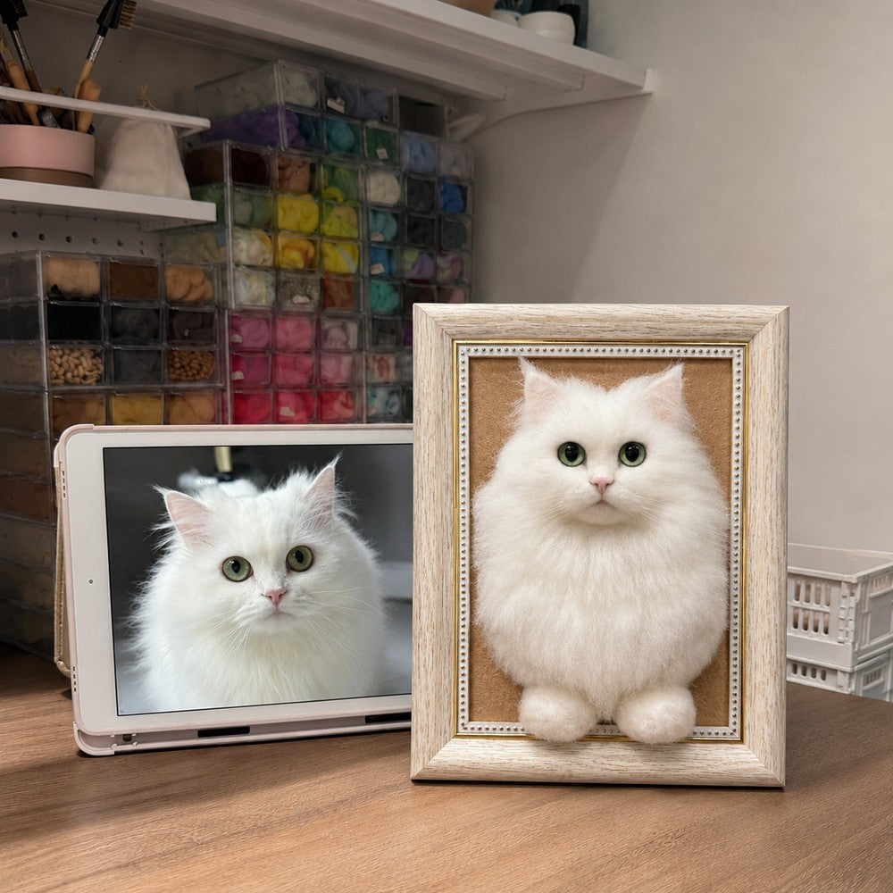 Handmade full-body 3D felt portrait of a black and white tuxedo cat displayed in a wooden frame beside the cat’s reference photo.