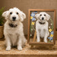Small white dog sitting beside its personalized floral pet portrait displayed in a wooden frame on an easel.