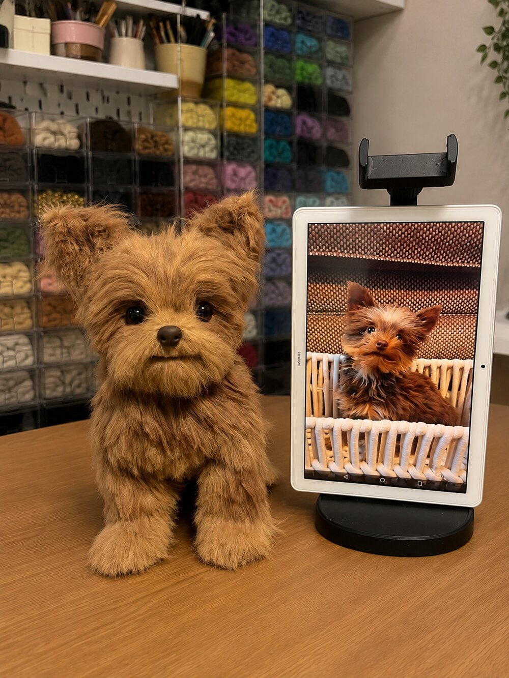 Handmade Yorkshire terrier pet replica displayed beside the customer's reference photo on a tablet.
